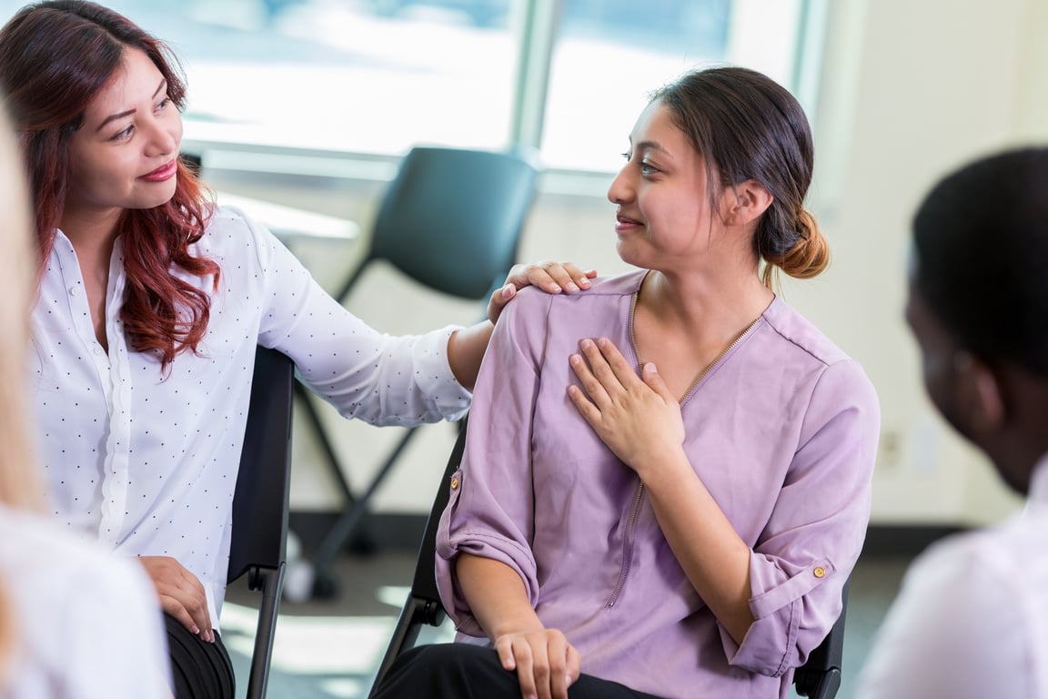 Women encourage each other during support group meeting