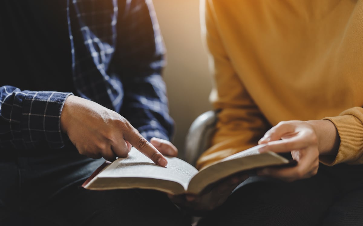 Christian couple or group reading study the bible together and pray at a home or Sunday school at church. concept studying the word of god.