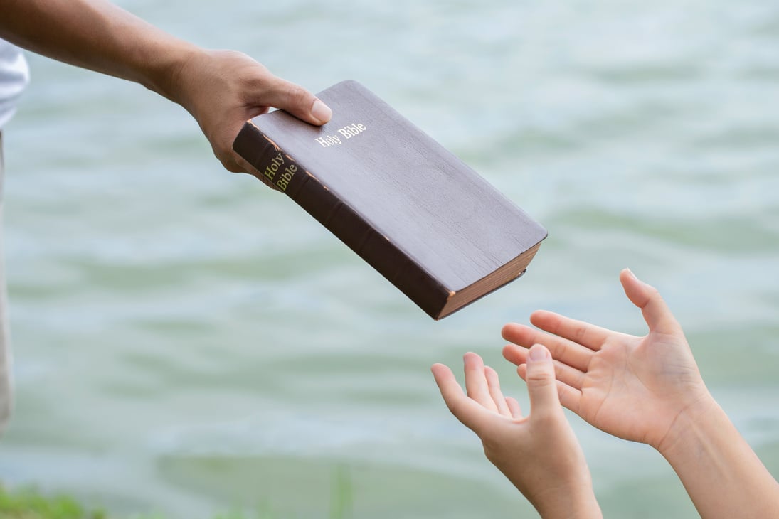 Man Giving the Bible to Woman